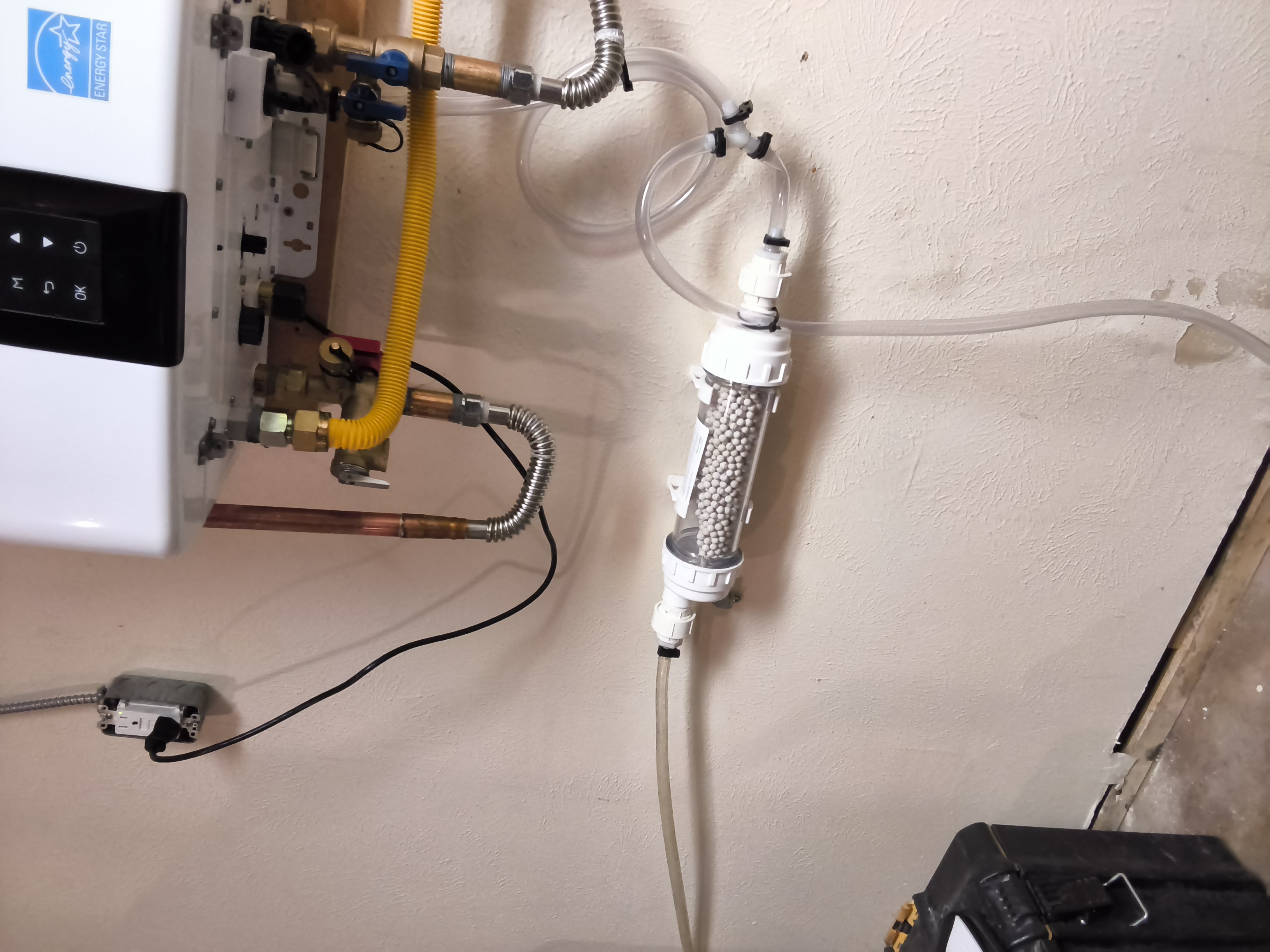 Scale prevention and tubing connection below tankless water heater
